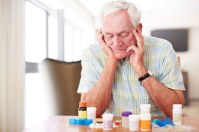 senior man overcome with medication