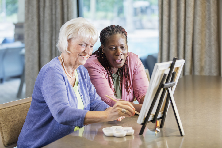 senior lady painting with friend