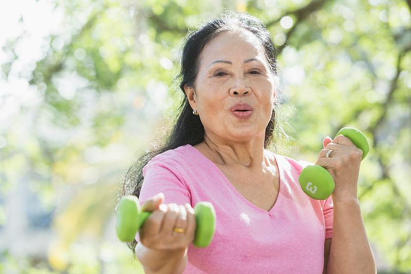 A senior woman exercises in order to avoid strokes.